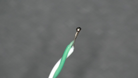 The junction of two alloys at the tip of a thermocouple probe